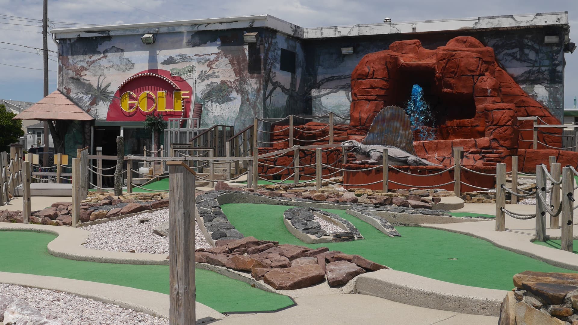 Jurassic Mini Golf course with dinosaurs and waterfall