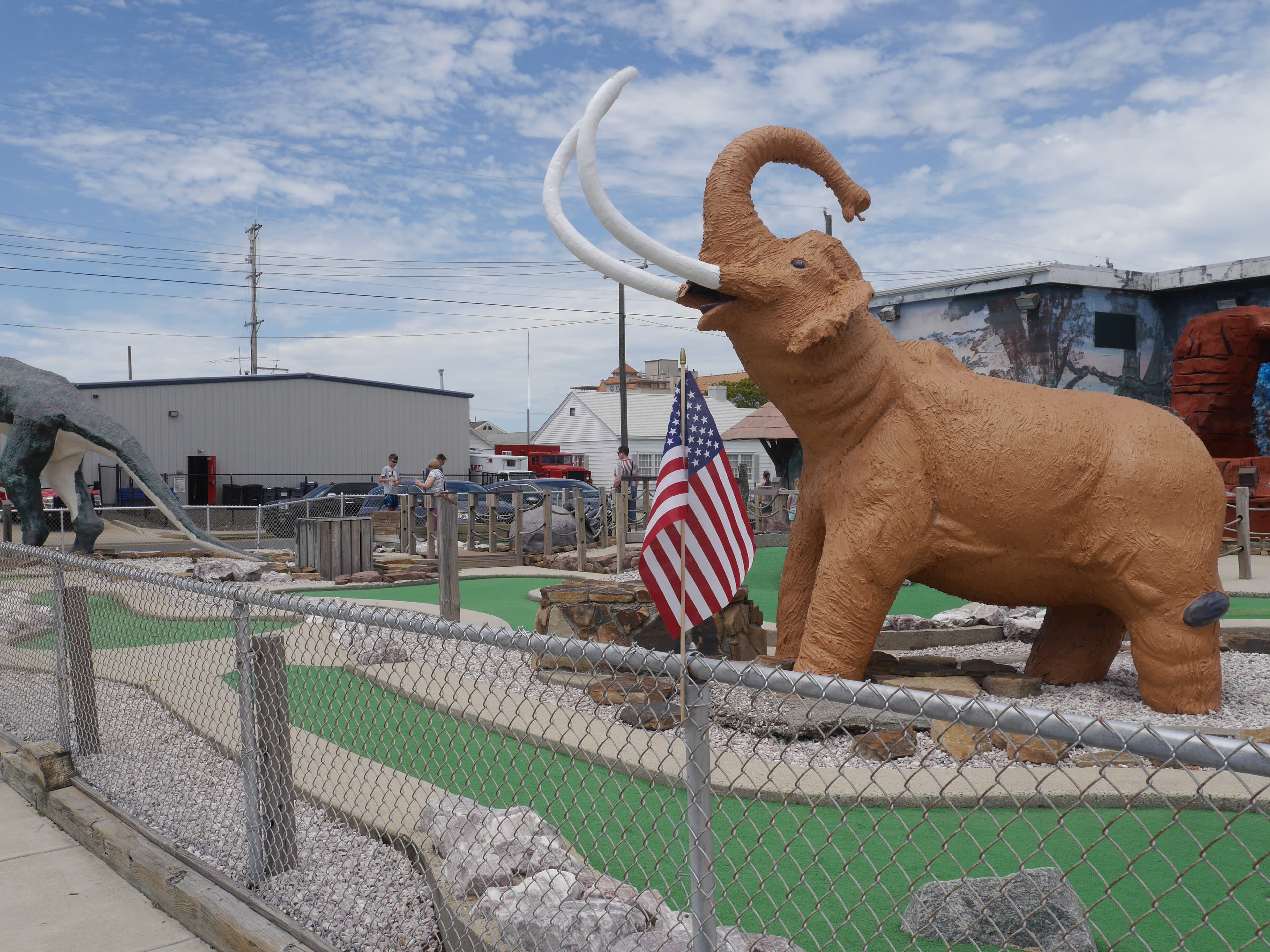 Mammoth statue at Jurassic Adventure Golf with American flag